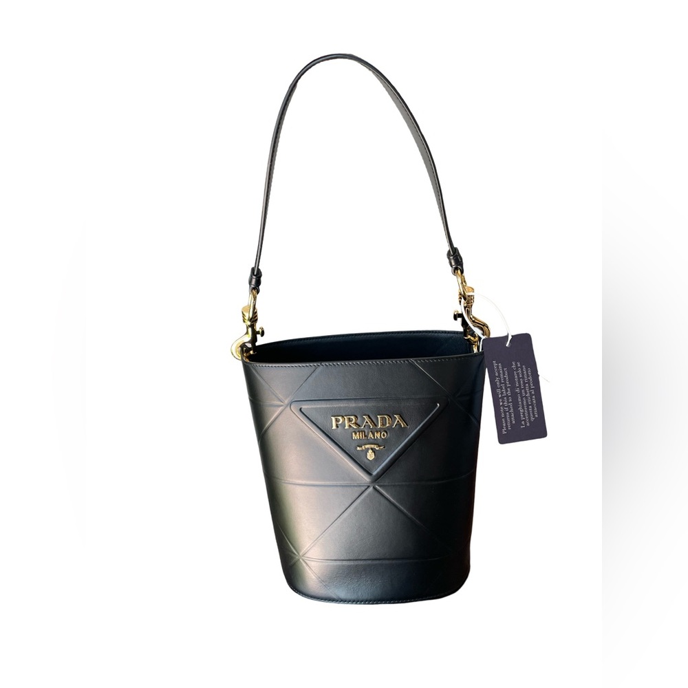 PRADA LOGO PLAQUE BUCKET BAG IN BLACK 1BE048